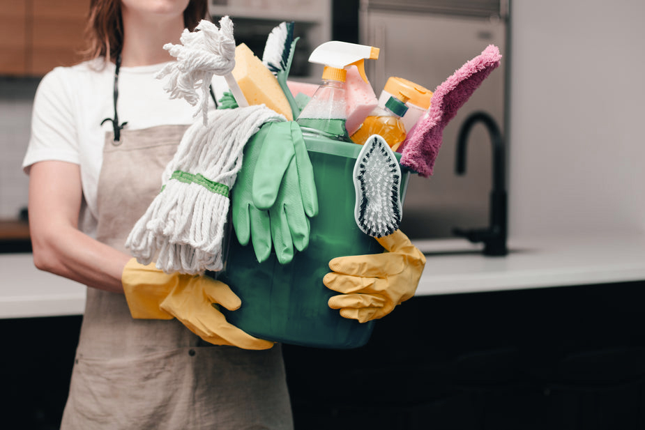 holding bucket of cleaning supplies copie